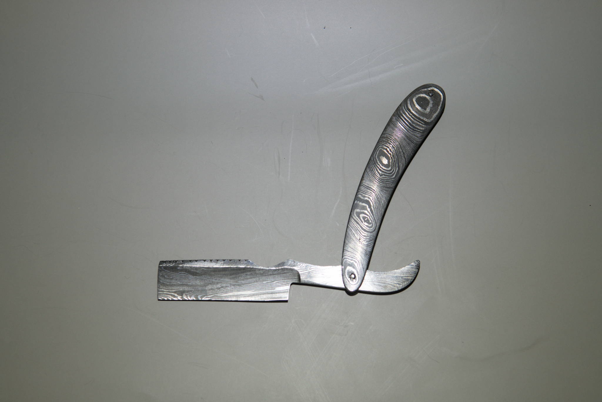 A hand made, damascus folding straight razor