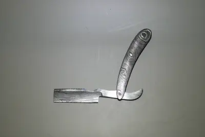 A hand made, damascus folding straight razor