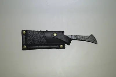 A straight handle damascus straight razor in a case