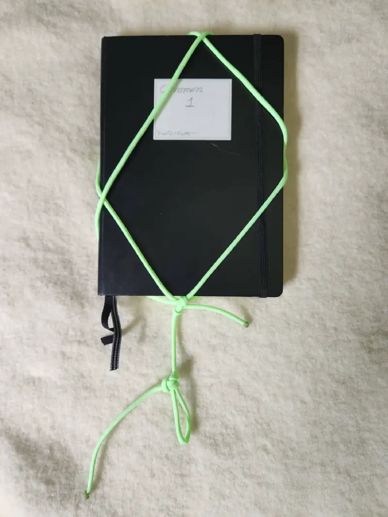 An A5 notebook wrapped for carrying
