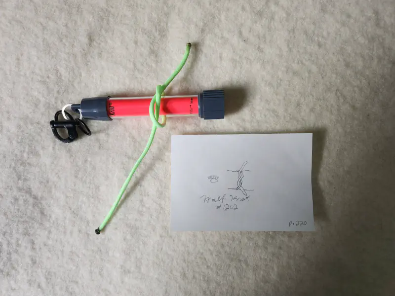 An example image showing the Half Knot (#1202) tied around a Krill AA glow stick light