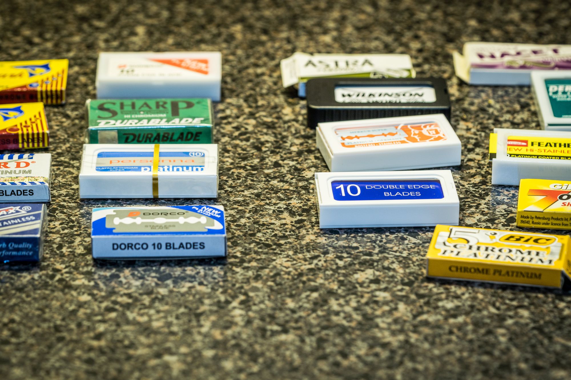 A number of packs of razor blades on the counter