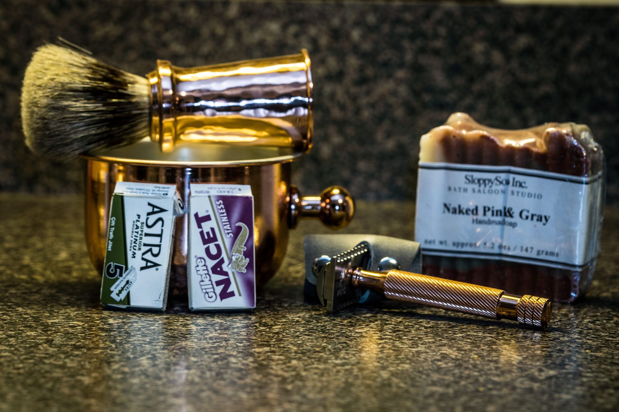 A shave brush, DE safety razor, shave cup, razor blade packs and bar soap