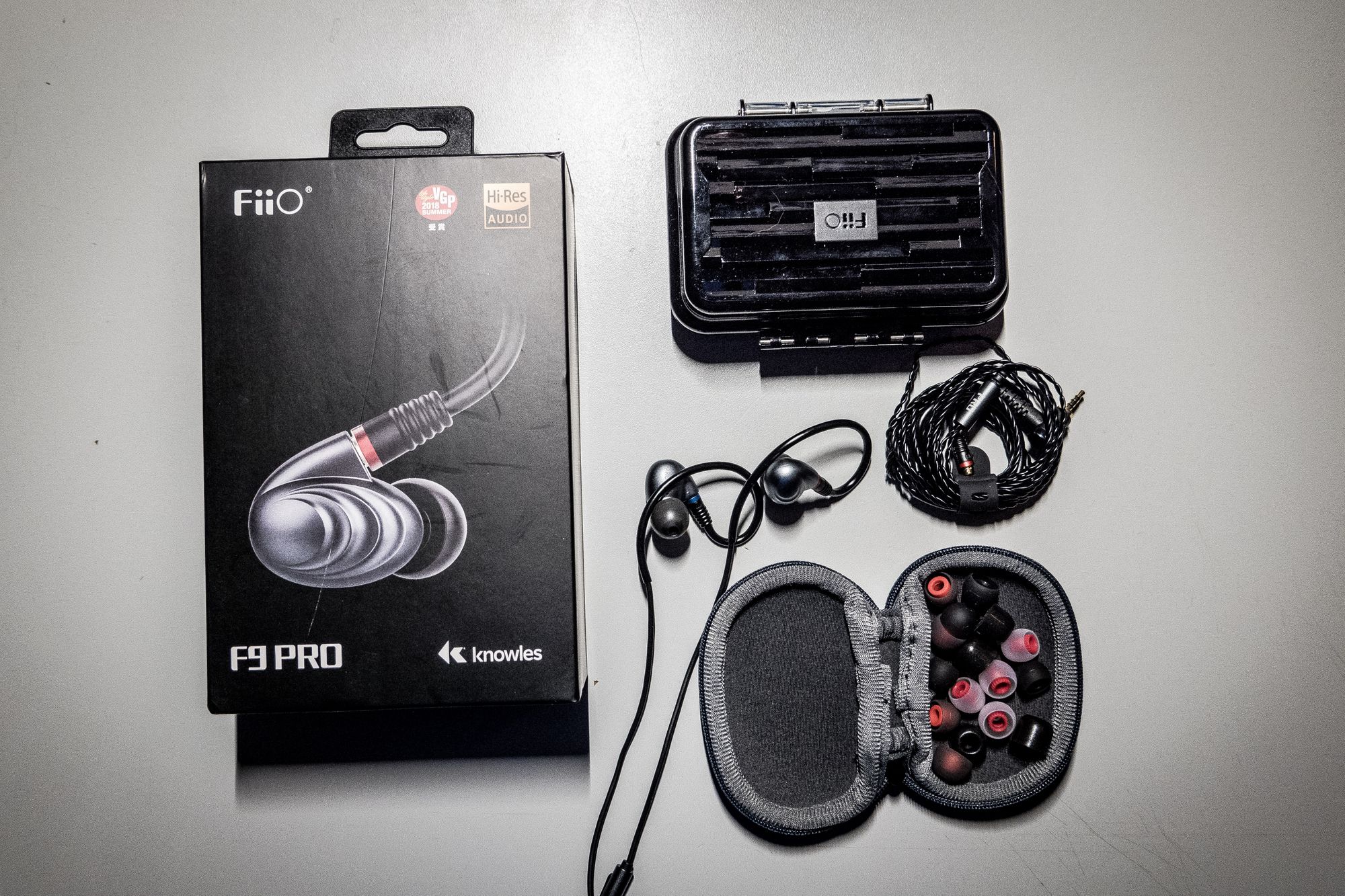 The FiiO F9 Pro box and its contents sitting on a desk