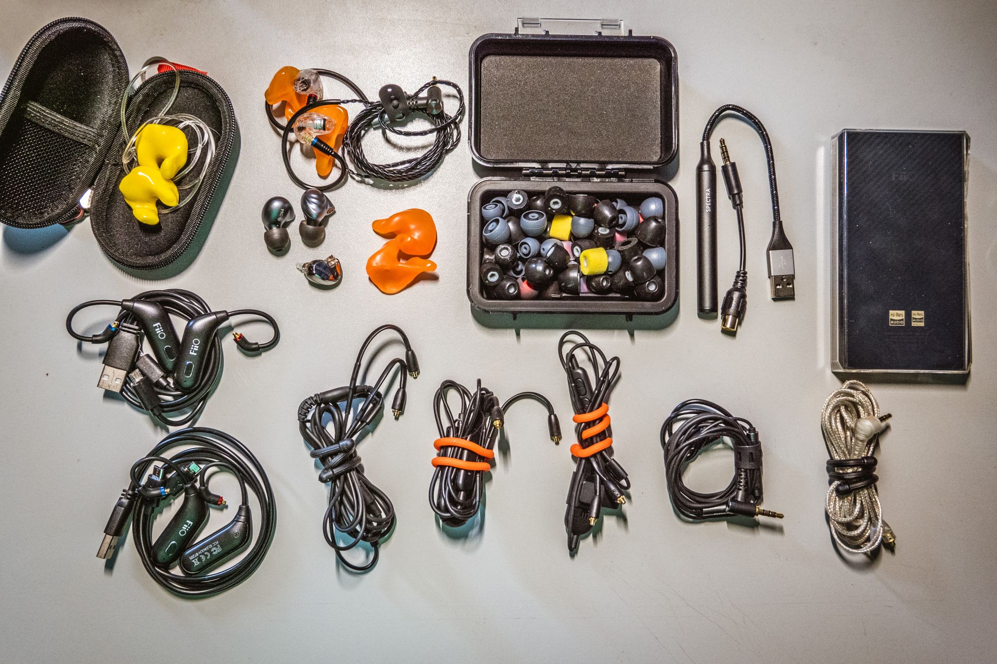 A FiiO m11, 2 sets of FiiO UTWS1's, 2 Shure BT cables, 2 balanced headphone wires, DAC, hearing protection, molded ear pieces, standard ear pieces, broken Sure ear buds